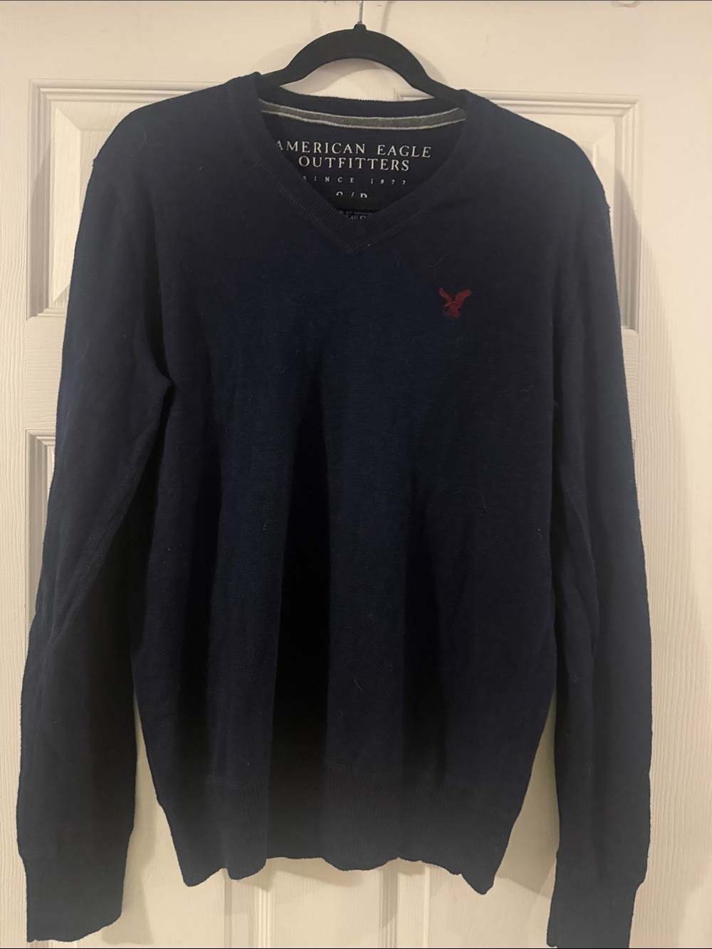 American Eagle Outfitters Men's Dark Navy V-Neck Sweater with Red Logo